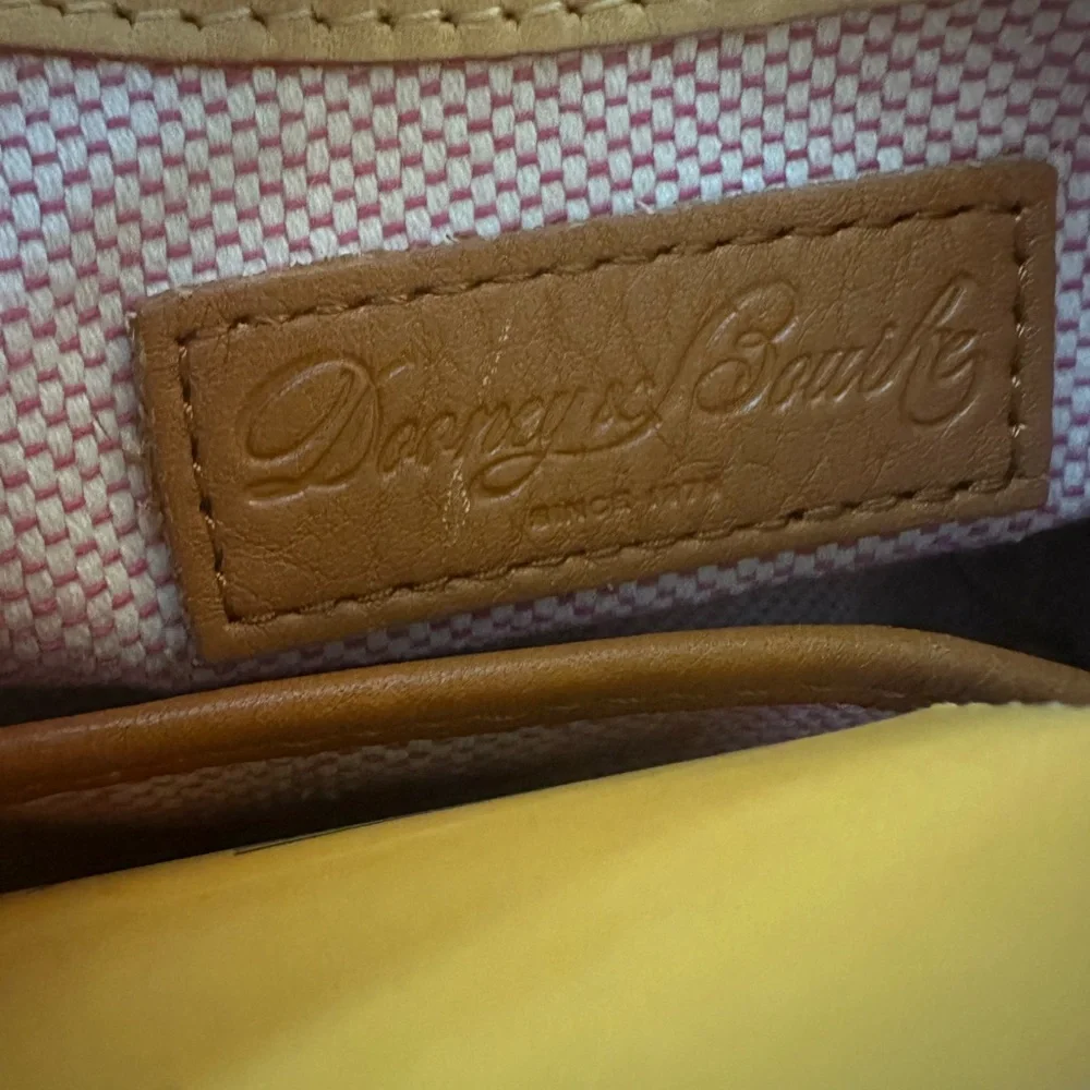 Dooney & Bourke Pebbled Grain Pocket Sac Crossbody with Side Pockets.